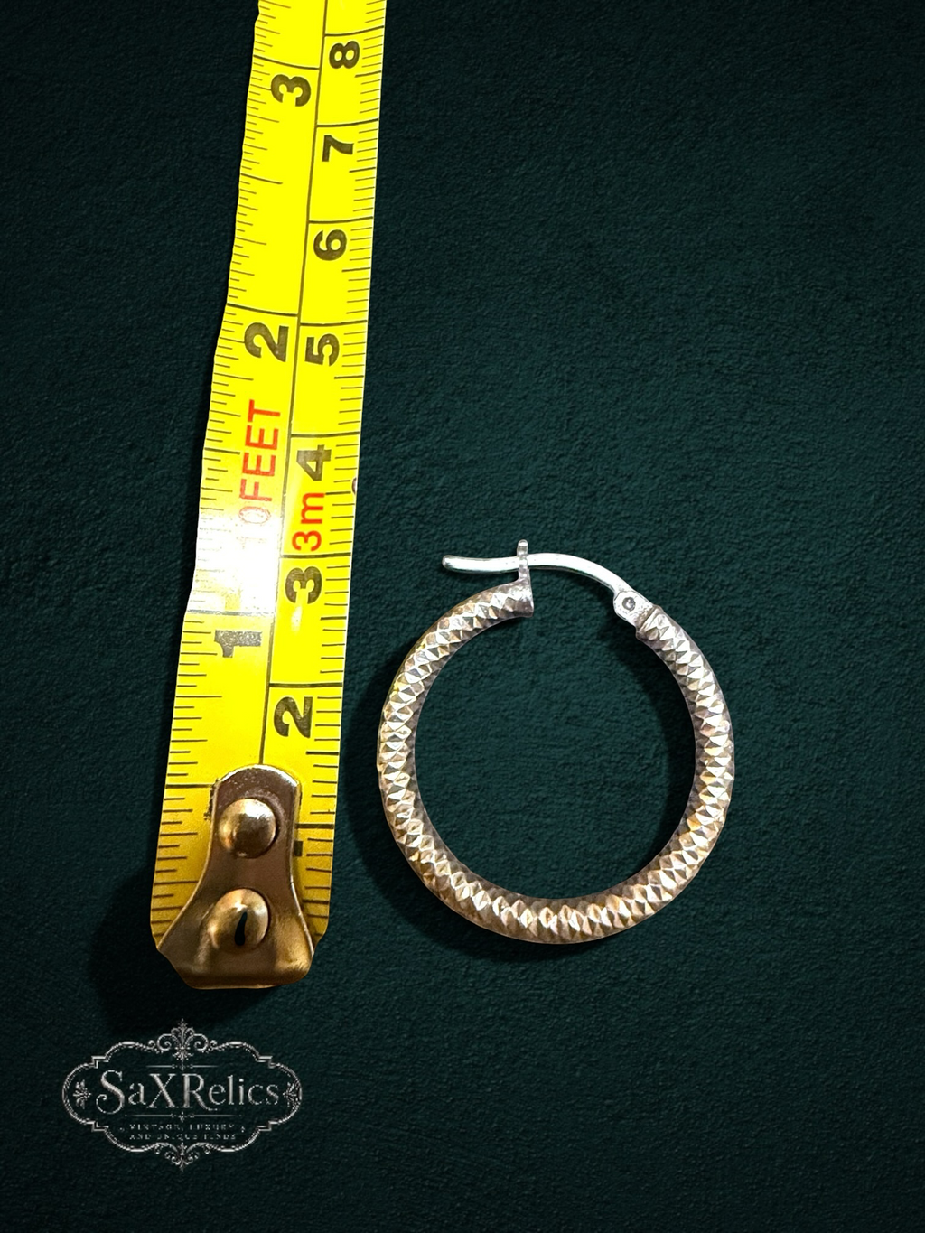 Faceta diamond-cut sterling silver hoops showing the faceted surface and latch closure