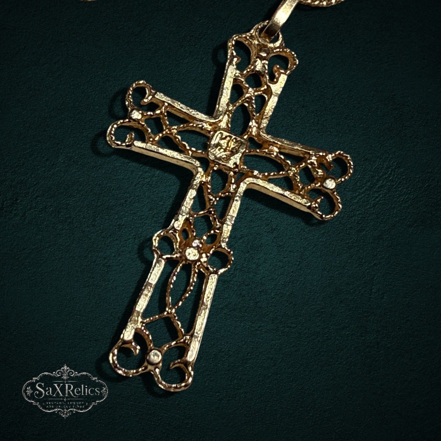 My Store 14k gold cross pendant featuring intricate openwork filigree detailing on a dark background
