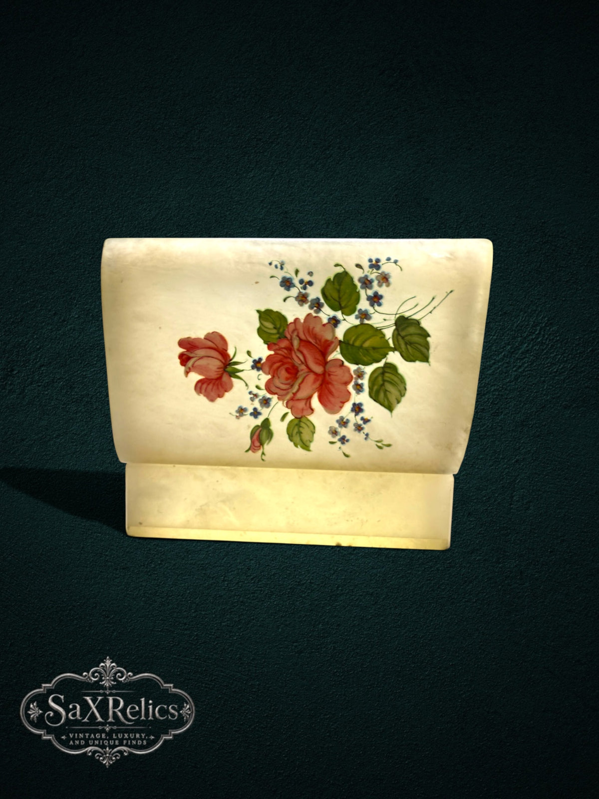 Alabaster trinket box with hand-painted pink rose and blue floral design on a creamy translucent stone lid