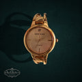 SaX Relics Anne Klein gold-tone open bangle watch with a genuine diamond accent at 12 o'clock