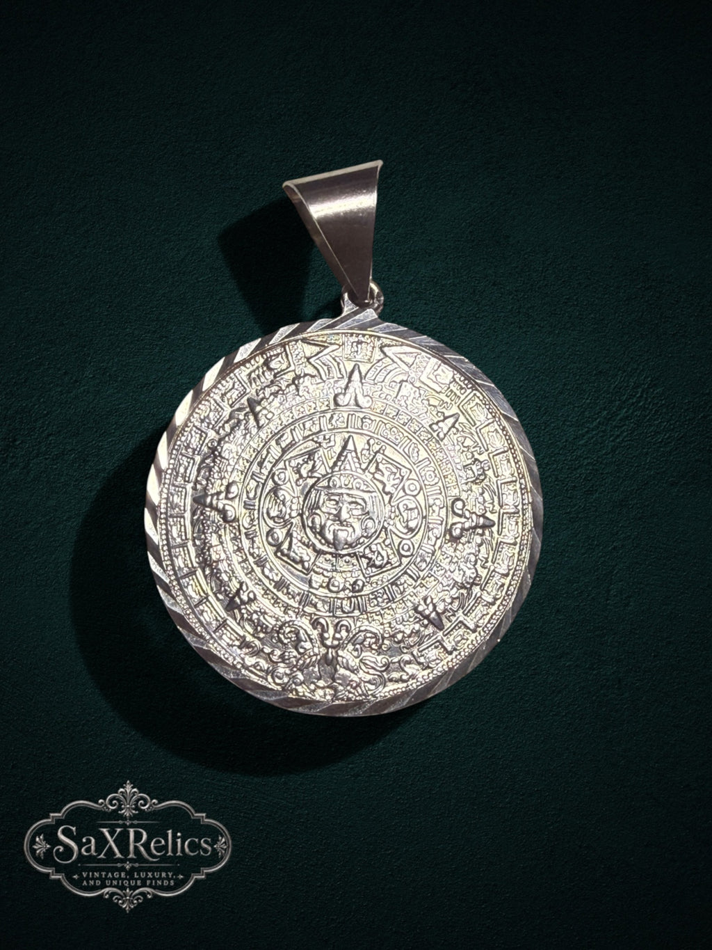 Artisan-crafted .950 silver Aztec Calendar pendant with intricate embossed detailing and twisted-rope border.