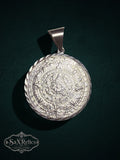 Artisan-crafted .950 silver Aztec Calendar pendant with intricate embossed detailing and twisted-rope border.