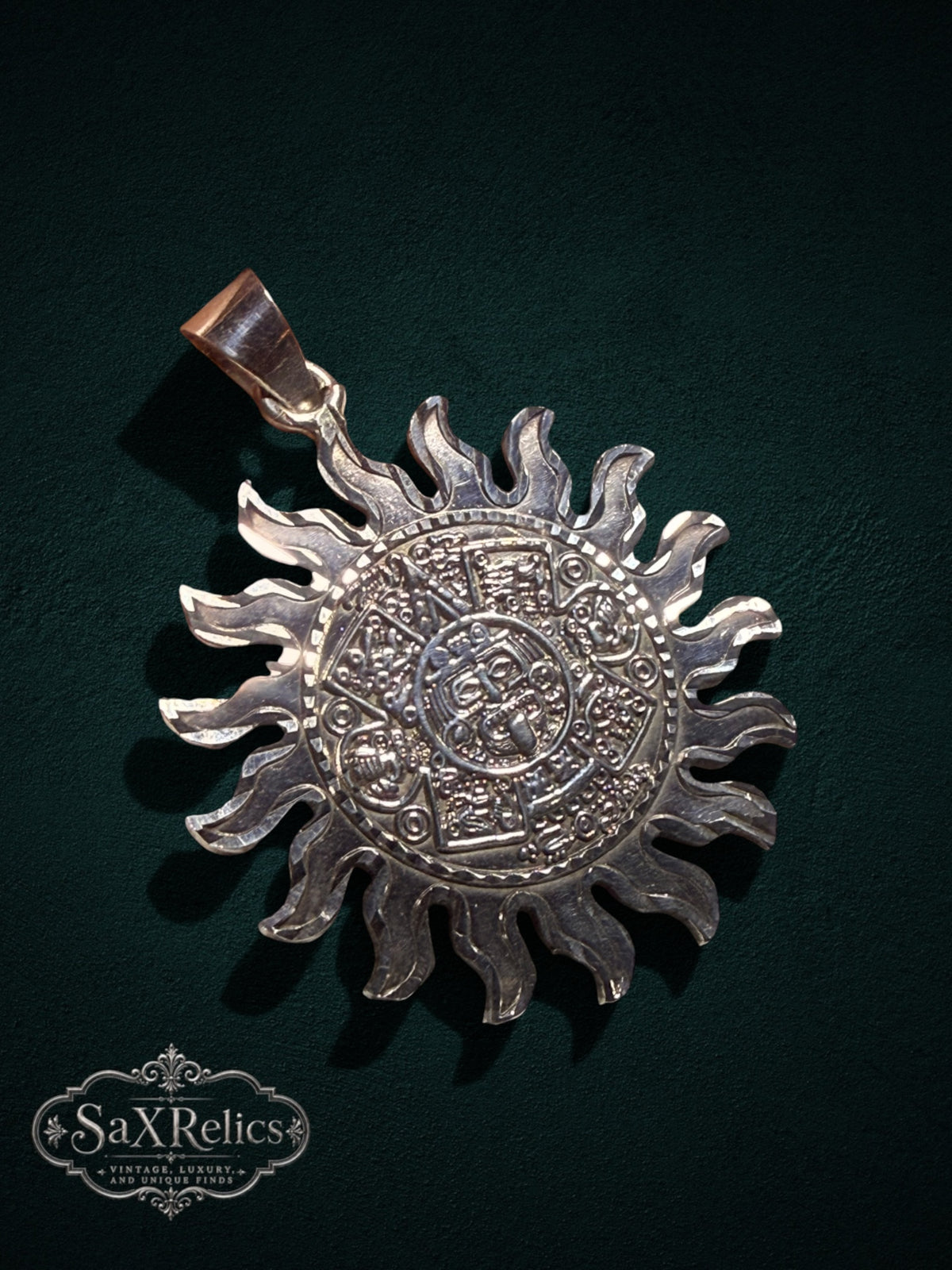 .950 silver Aztec calendar sun pendant with intricate Mesoamerican detailing on a dark background