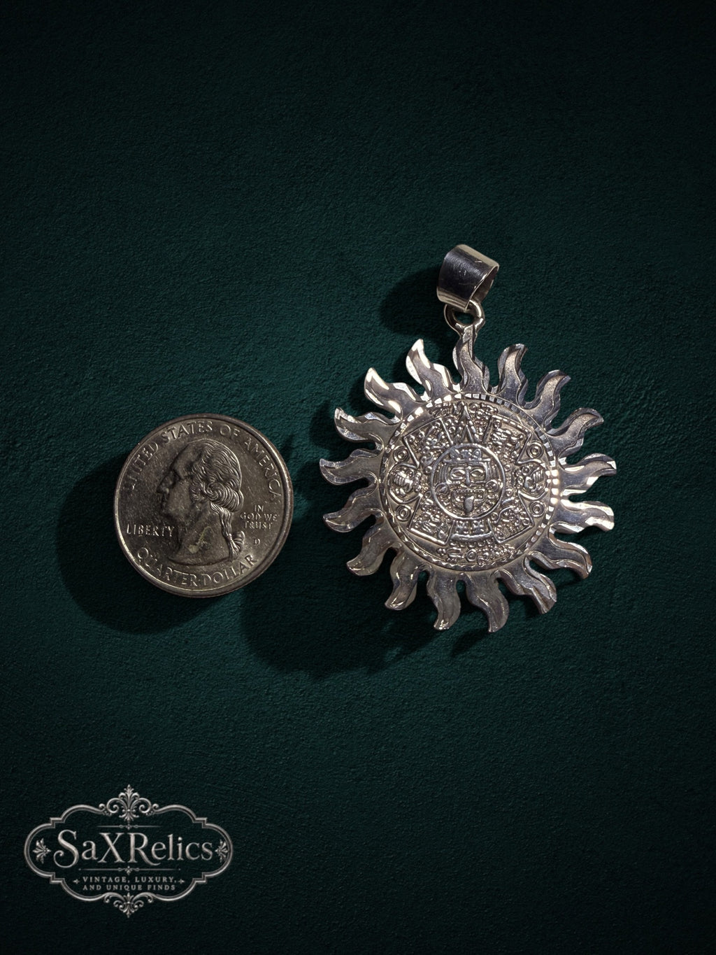 .950 silver Aztec calendar sun pendant next to a US quarter for scale