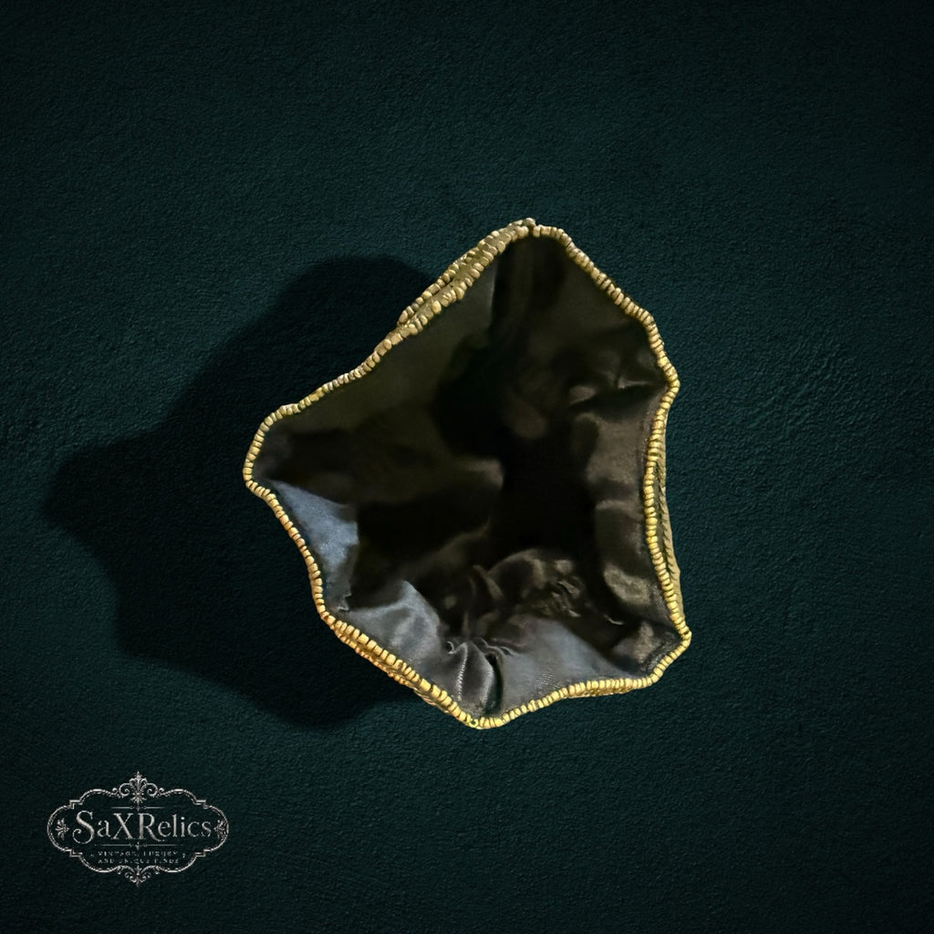 My Store SAXRelics black drawstring pouch with gold beaded trim, viewed from above against a dark background.