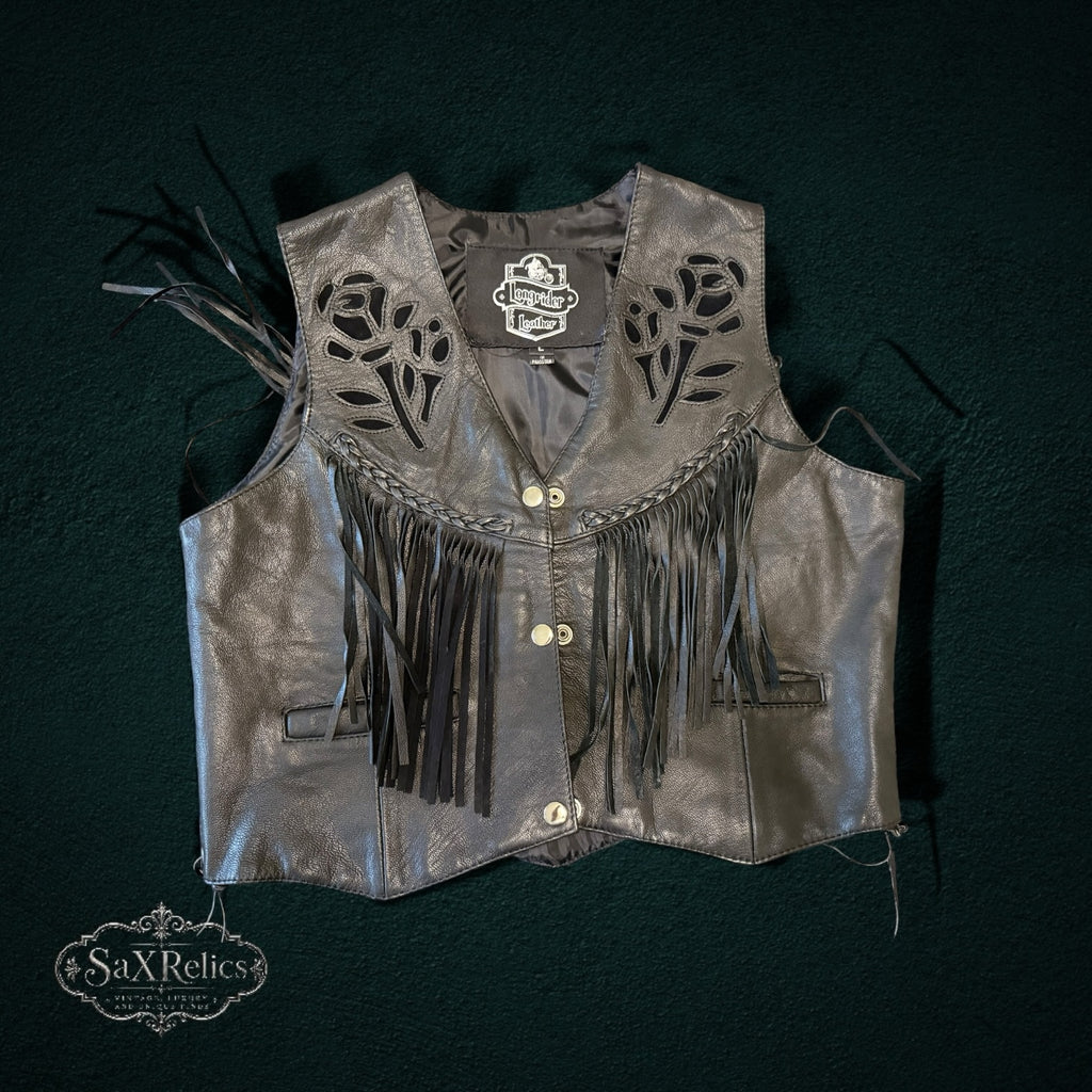My Store black leather motorcycle vest with laser-cut rose motifs, fringe detailing, and braided trim.