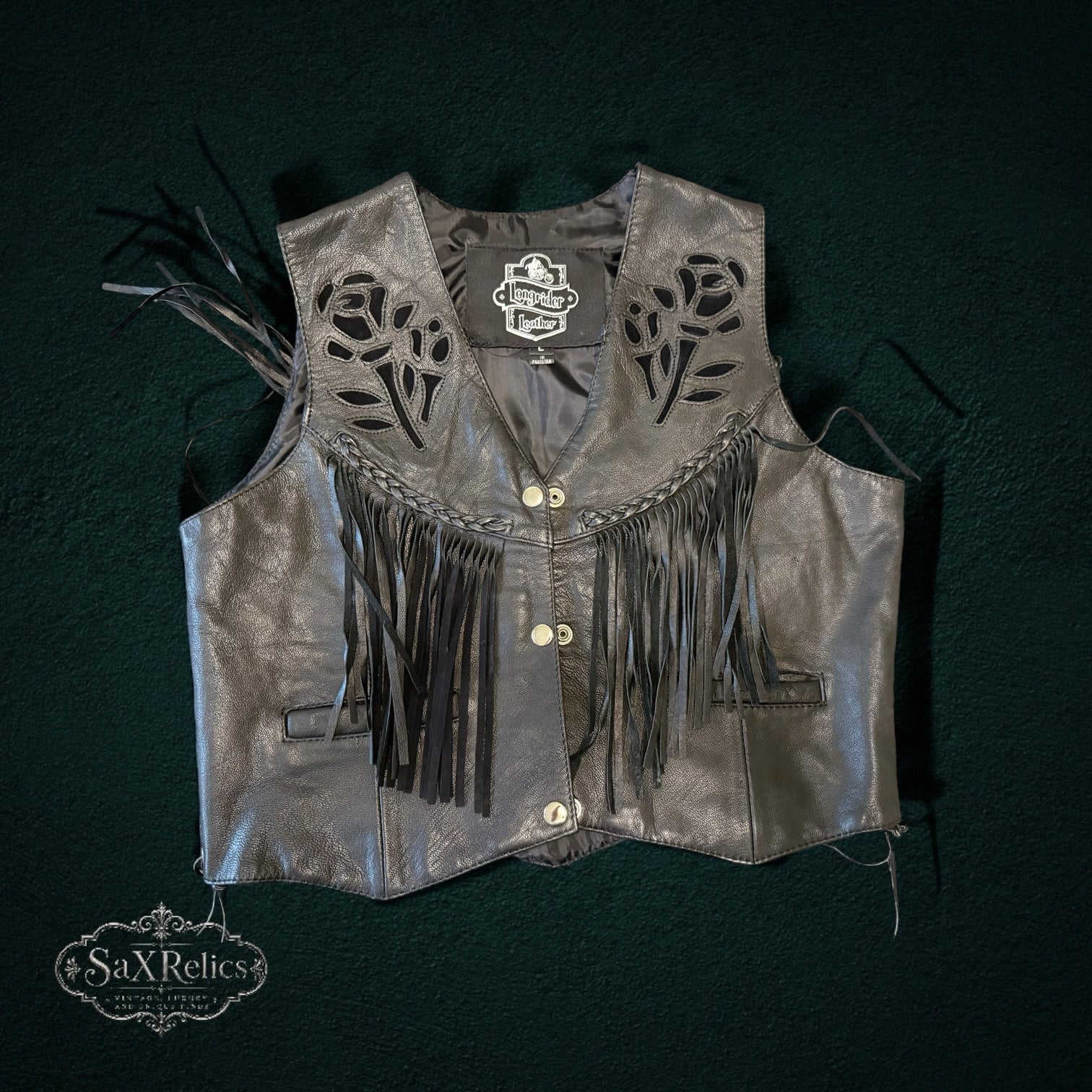My Store black leather motorcycle vest with laser-cut rose motifs, fringe detailing, and braided trim.
