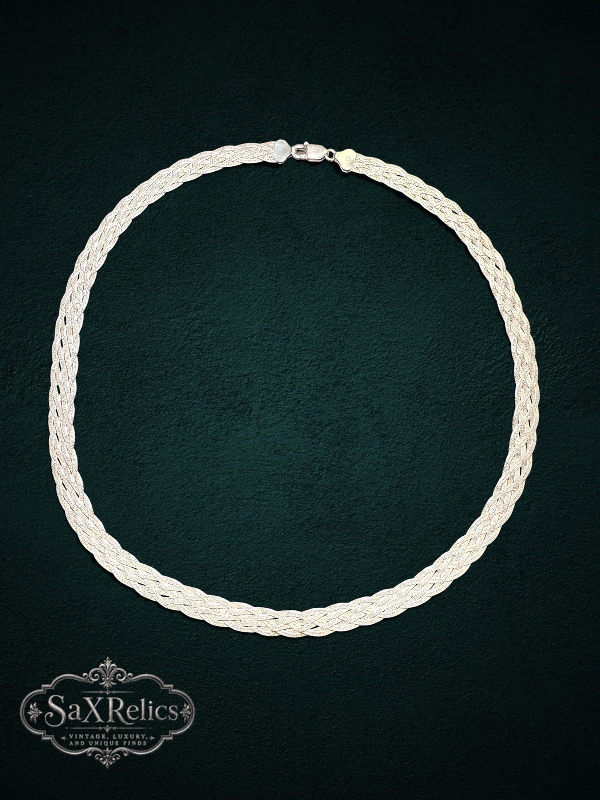 Braided sterling silver multi-strand chain necklace with a secure clasp on a dark textured background.