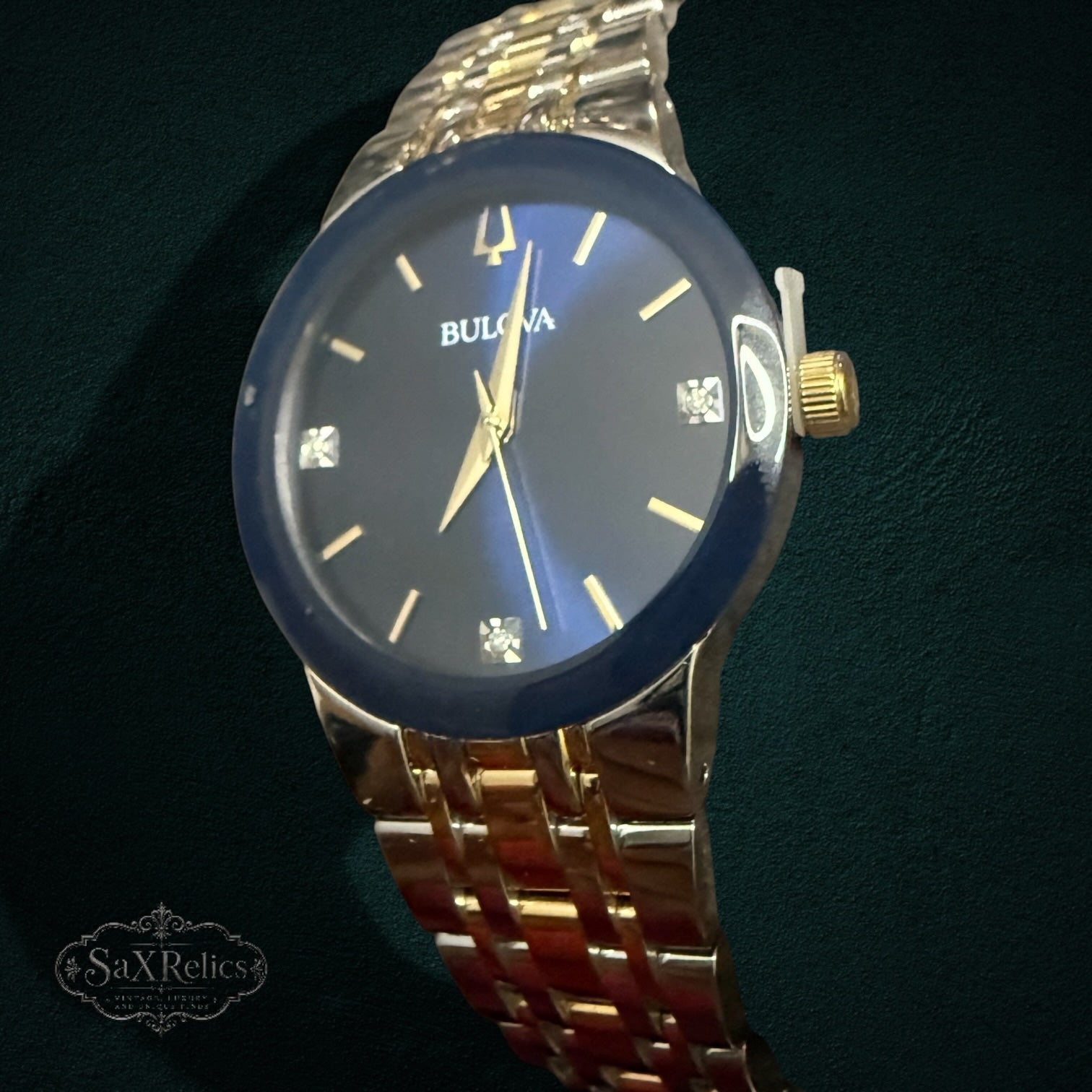 My Store Bulova stainless steel watch with a deep blue dial, diamond markers, and a two-tone silver and gold bracelet.