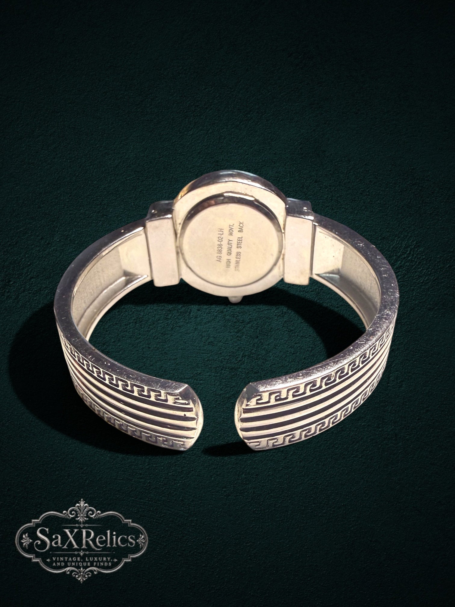 My Store Carolina cuff watch back view showing stainless steel casing and intricate silver Greek key motif band