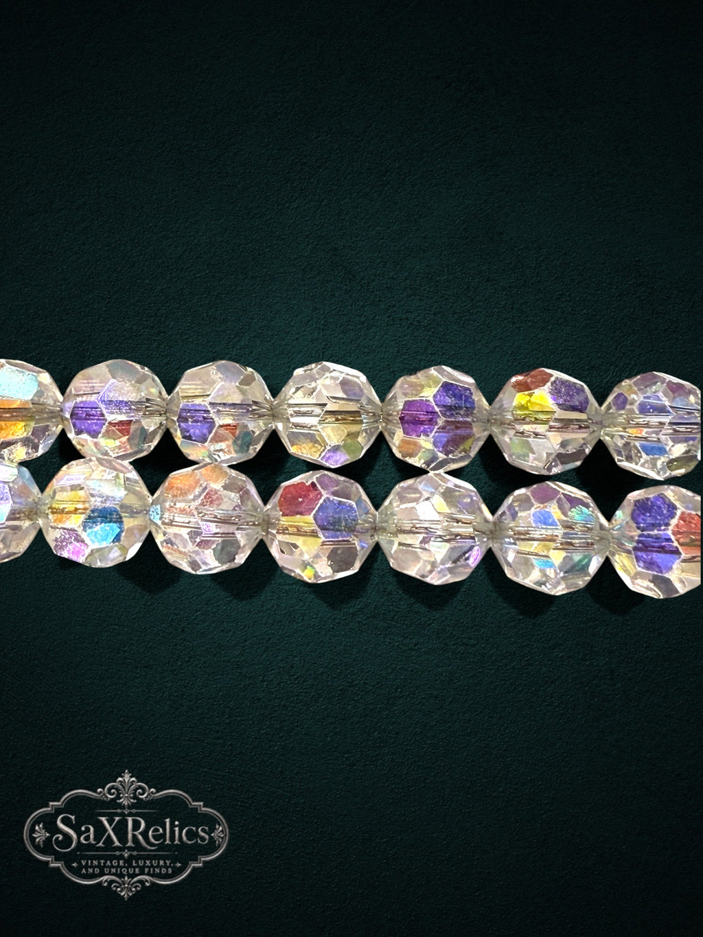 SaX Relics double-strand crystal bracelet with iridescent aurora borealis faceted beads on a dark background