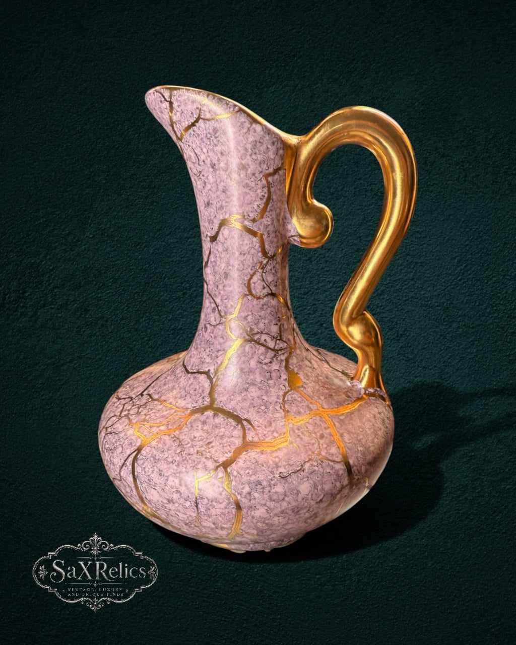 My Store SaxRelics ceramic pitcher in dusty rose with gold kintsugi-style crackle detailing and a sweeping handle.