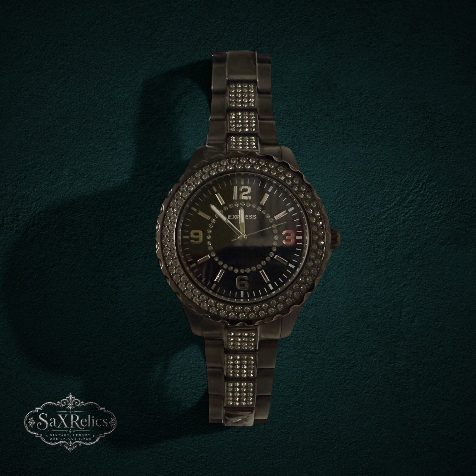 My Store EXPRESS dark metal link wristwatch with a crystal-encrusted bezel and matching bracelet accents