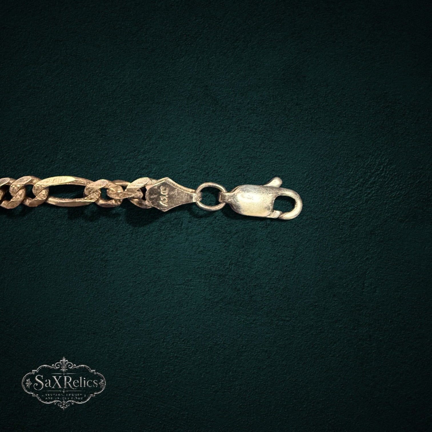 My Store sterling silver Figaro chain bracelet featuring a secure lobster claw clasp and polished link texture.