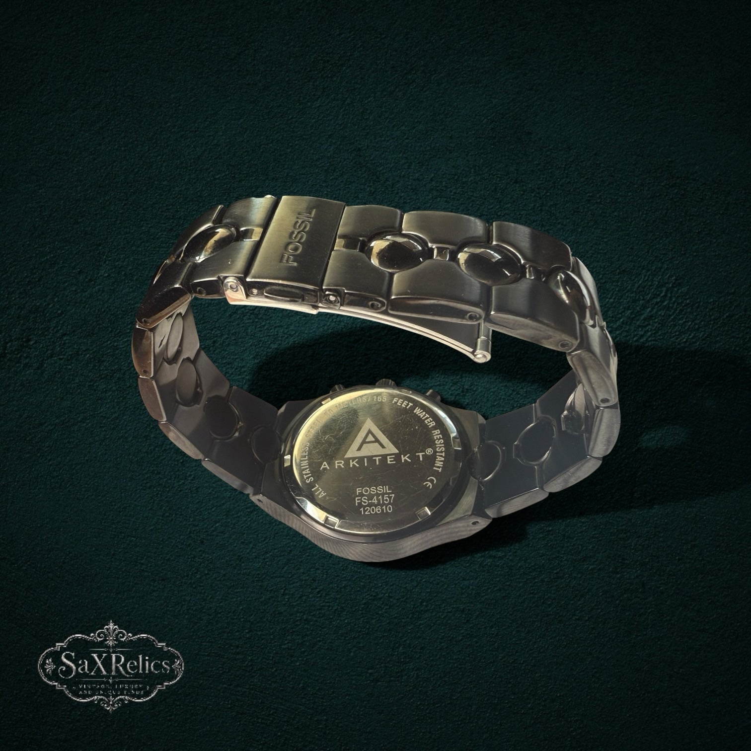 My Store Fossil Arkitekt stainless steel chronograph watch showing the engraved case back and articulated link bracelet