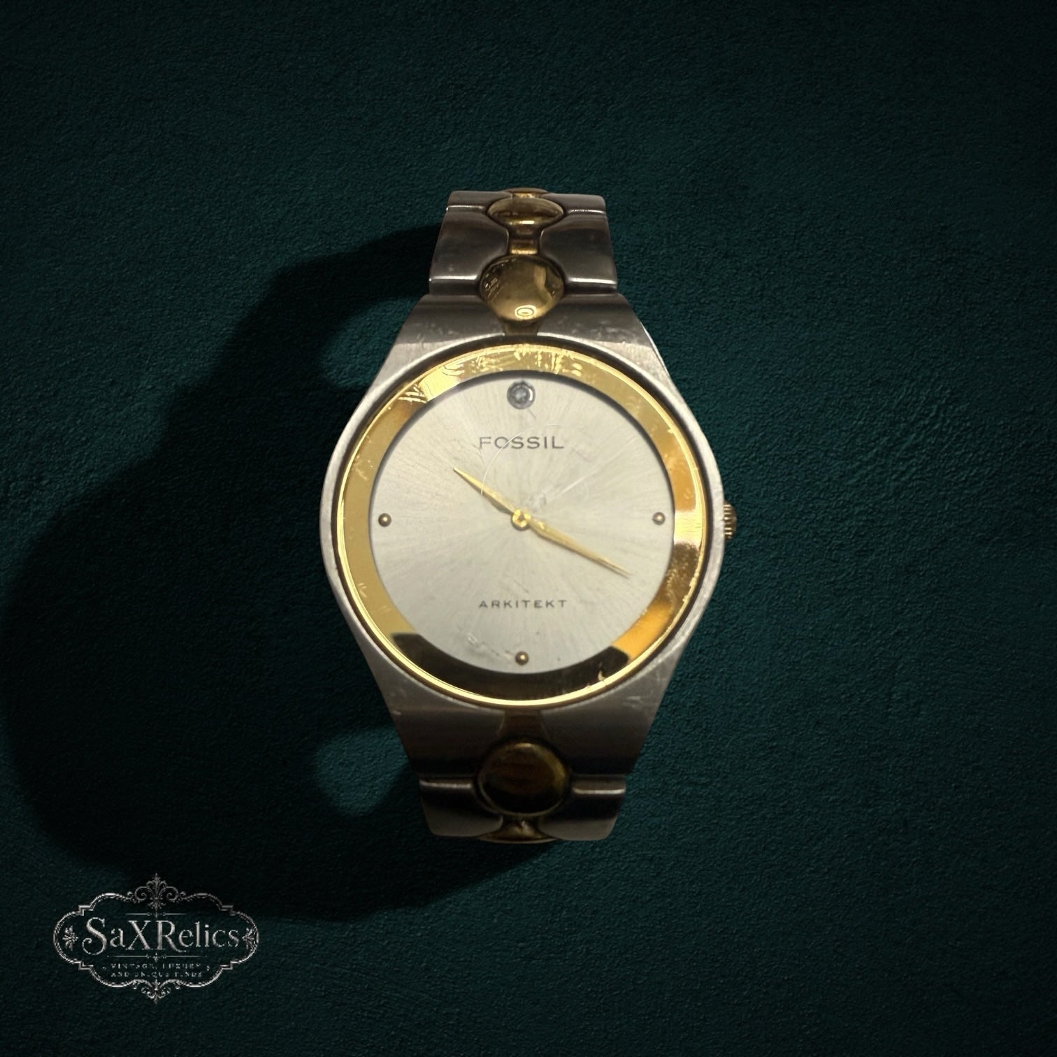 My Store Fossil Arkitekt two-tone stainless steel wristwatch with a silver dial and gold-tone circular link bracelet.