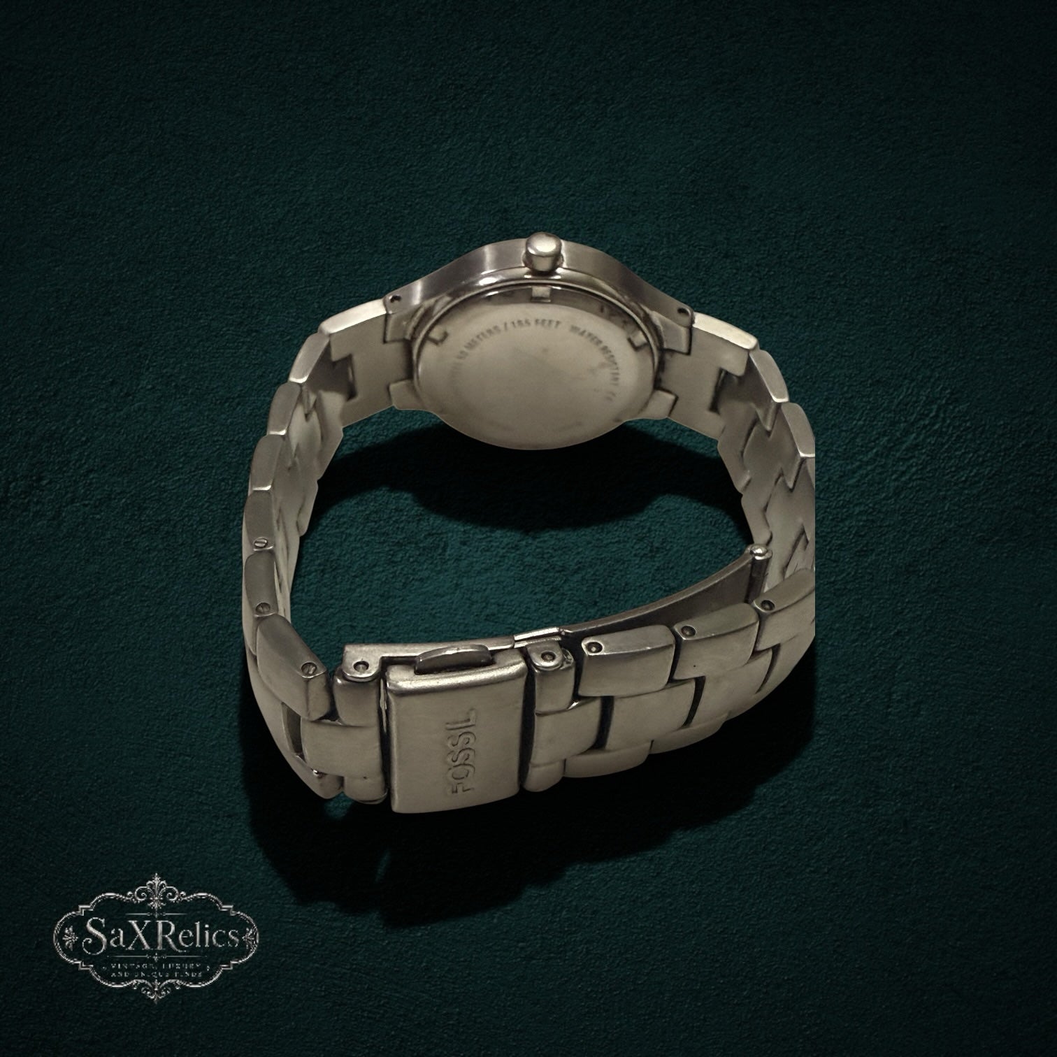 My Store Fossil stainless steel wristwatch showing the brushed metal link bracelet and secure clasp from the back