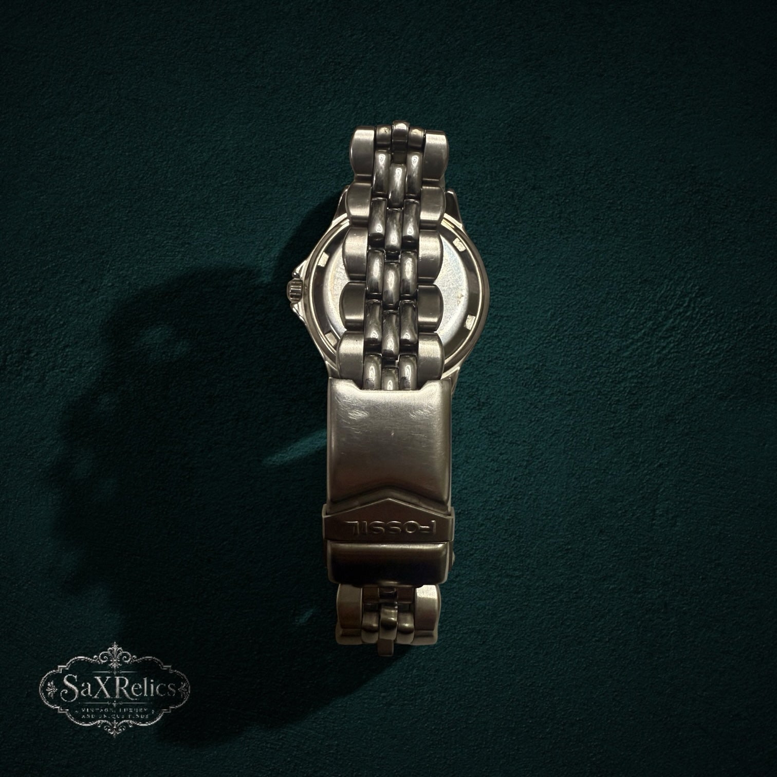 My Store Fossil stainless steel watch showing the back of the case and metal link bracelet with deployment clasp