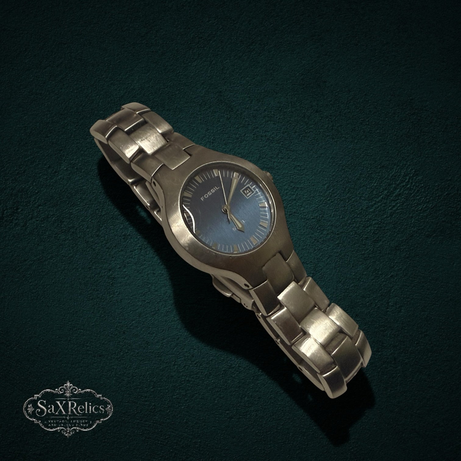 My Store Fossil stainless steel analog watch with a deep blue sunray dial and brushed metal link bracelet.