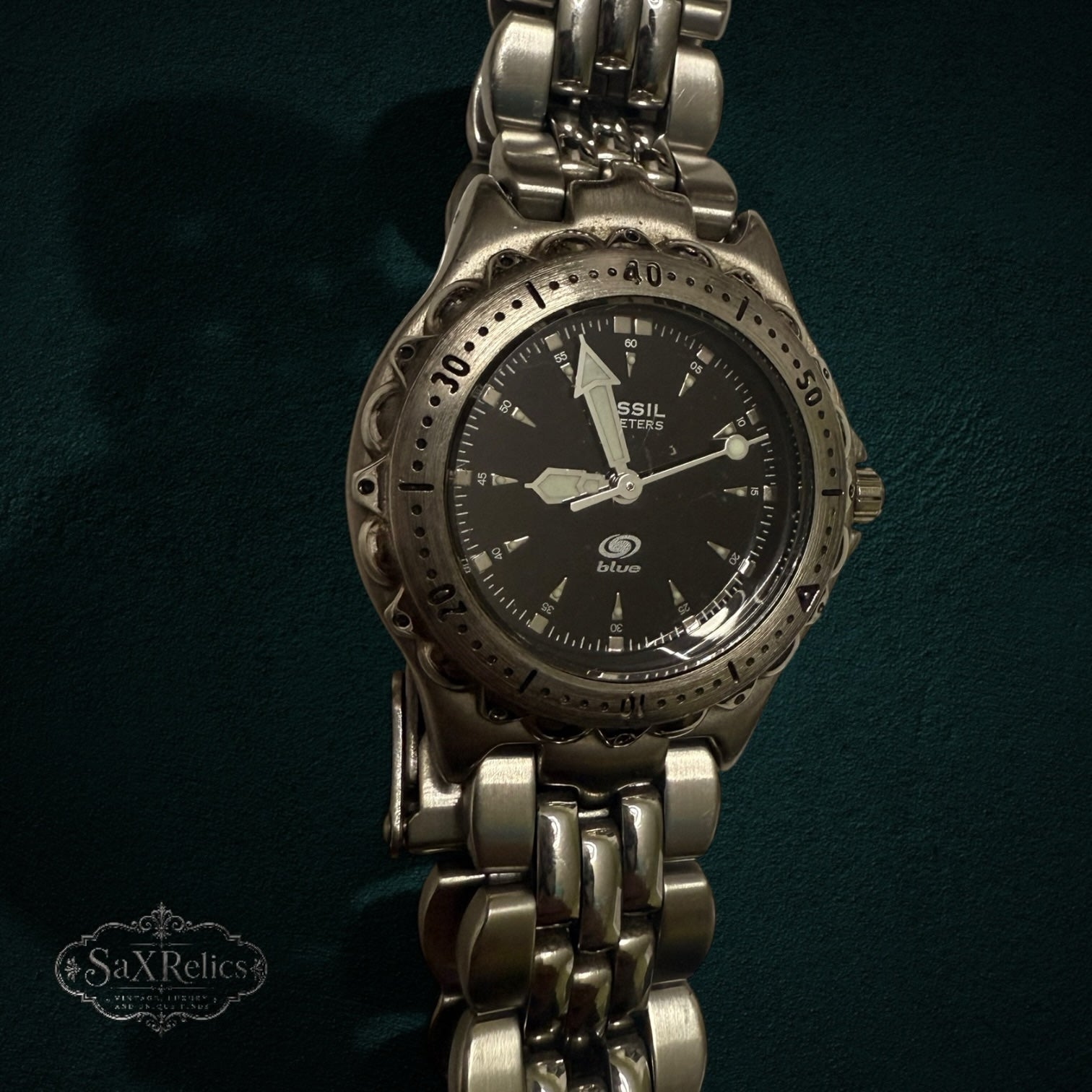 My Store Fossil Blue stainless steel analog wristwatch with a black dial and textured bezel on a link bracelet.