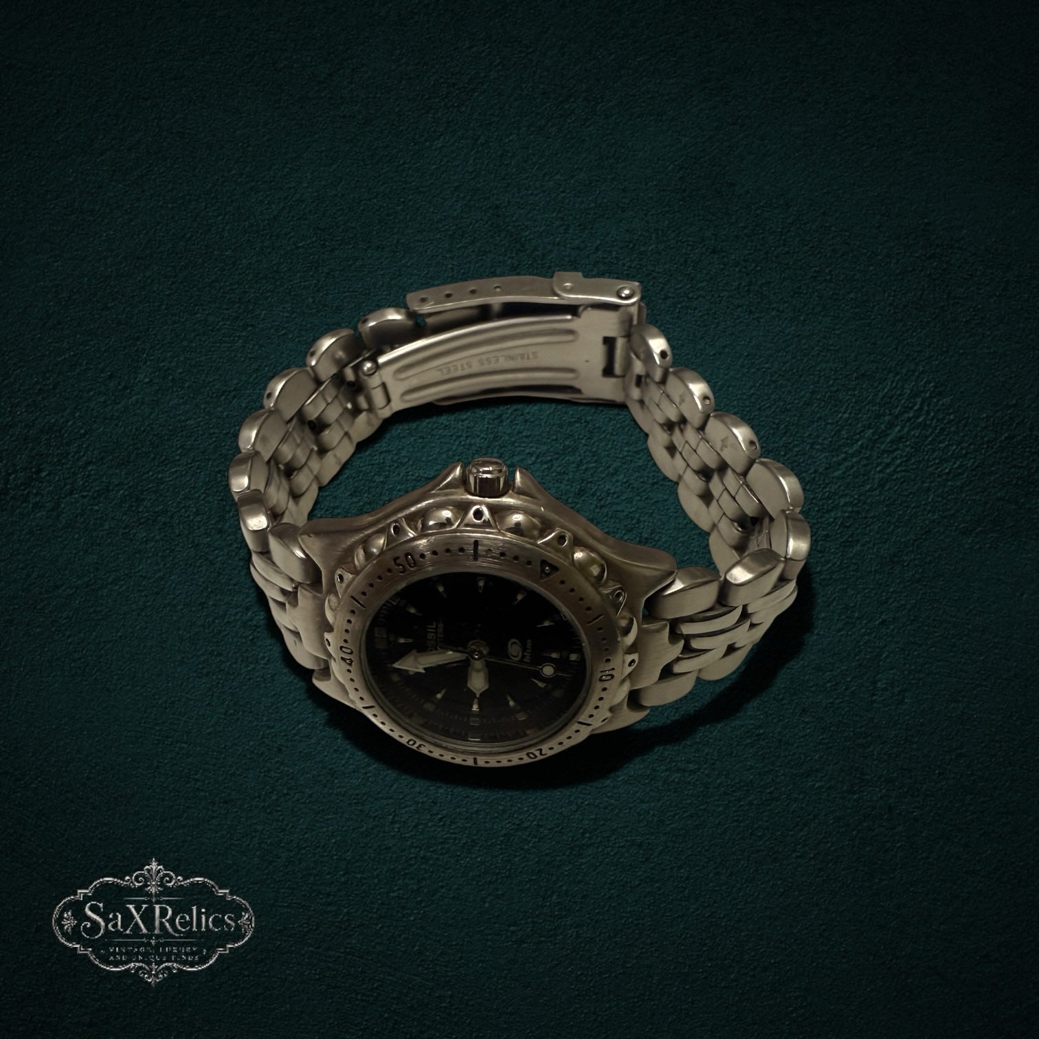 My Store Fossil stainless steel analog wristwatch with a black dial and textured bezel on a link bracelet