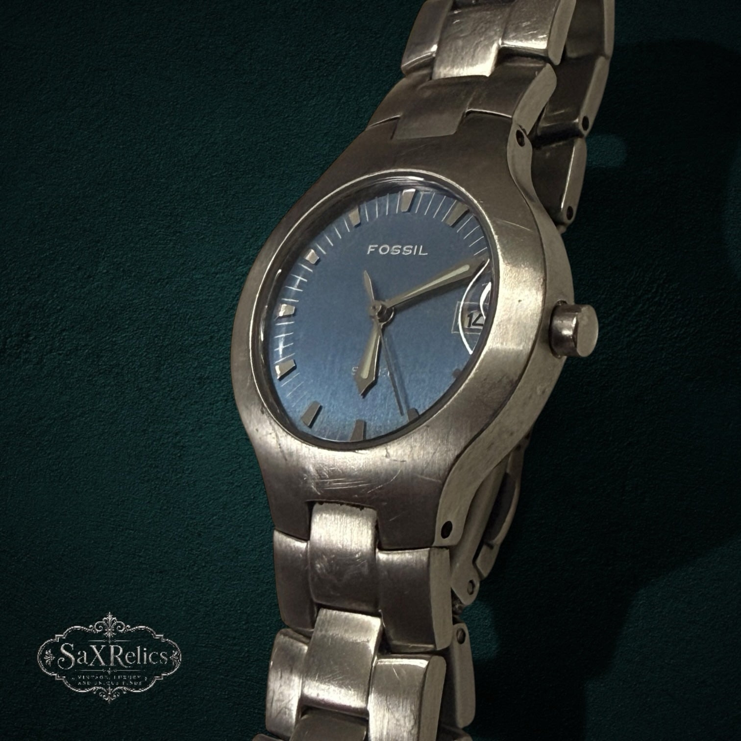My Store Fossil stainless steel analog wristwatch with a blue sunray dial and brushed metal link bracelet.