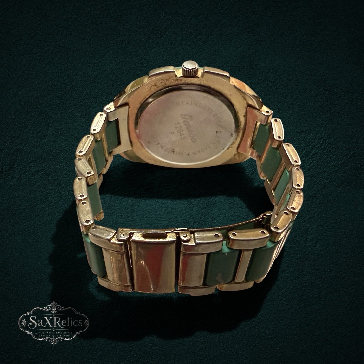 My Store Geneva analog wristwatch featuring a gold-tone link bracelet with mint green accents and stainless steel back
