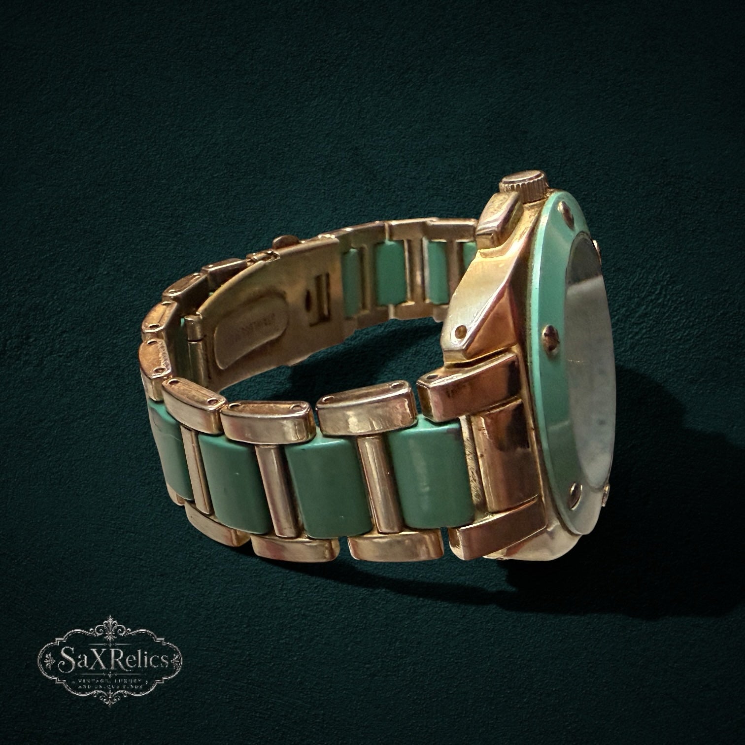 My Store Geneva analog wristwatch featuring a gold-tone finish with mint green link bracelet accents, side view.