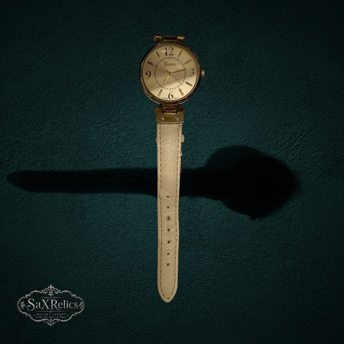 My Store Geneva analog wristwatch featuring a gold-tone round case and a cream-colored textured leather strap.
