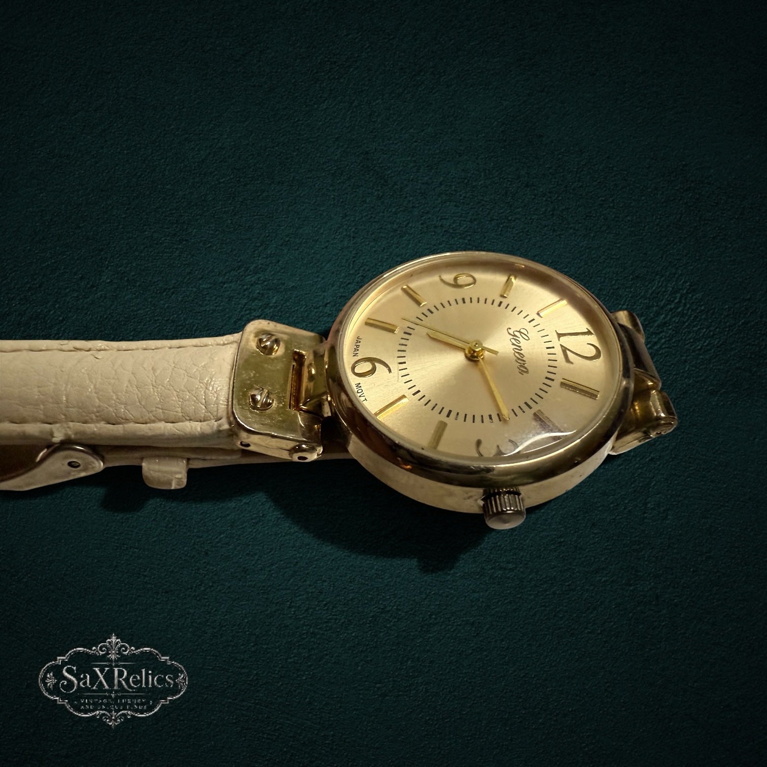 My Store Geneva analog wristwatch with a gold-tone round case and a cream-colored textured leather strap.