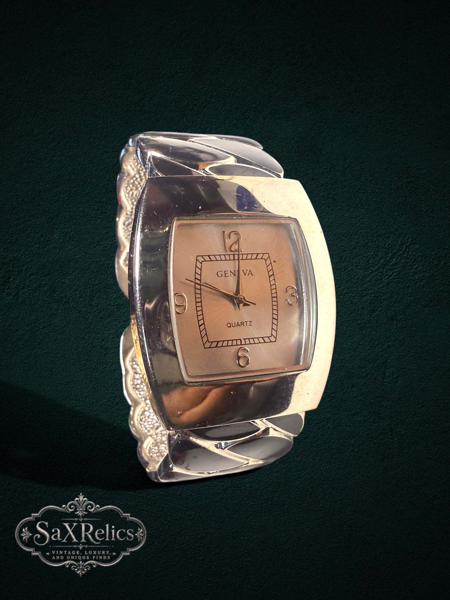 My Store Geneva quartz wristwatch featuring a rectangular face and a wide, sculptural silver-tone cuff bracelet.