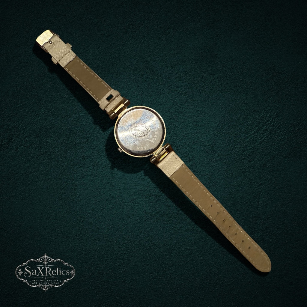 Back view of My Store Geneva analog wristwatch featuring a gold-tone case and a cream-colored textured leather strap.