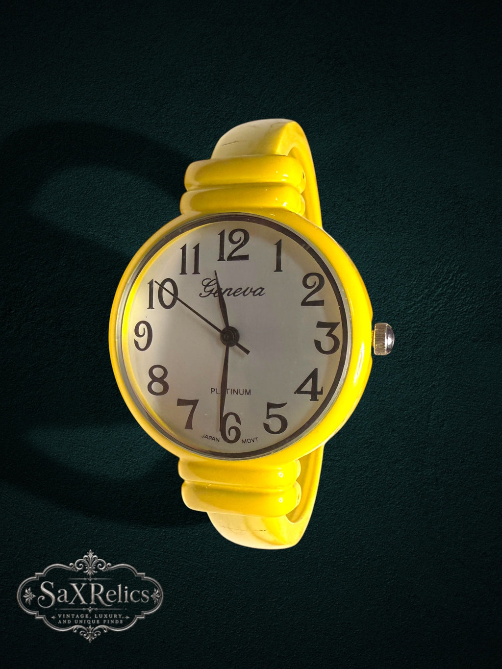 My Store Geneva analog wristwatch with a vibrant yellow bangle cuff, white dial, and black Arabic numerals.