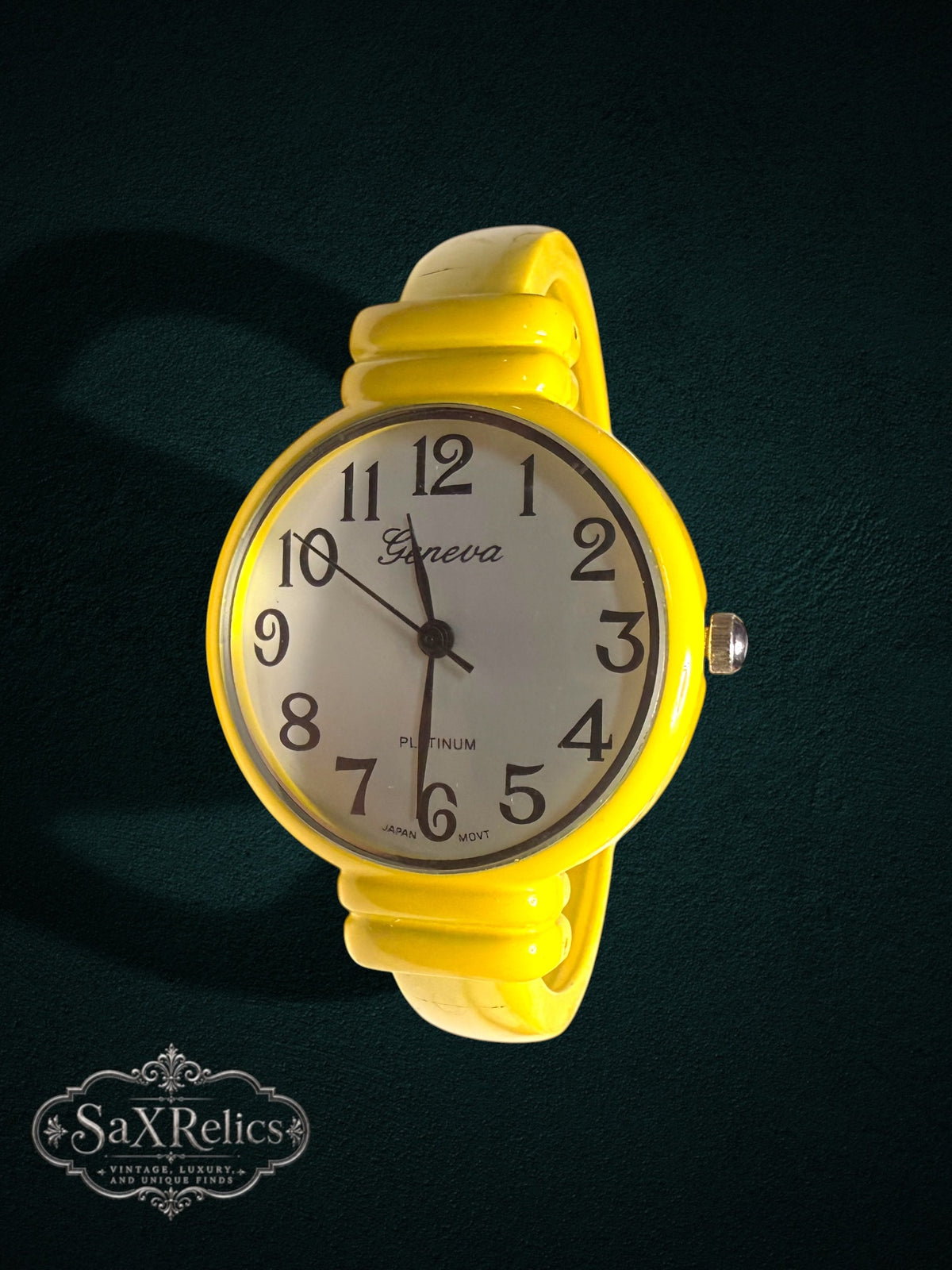 My Store Geneva analog wristwatch with a vibrant yellow bangle cuff, white dial, and black Arabic numerals.