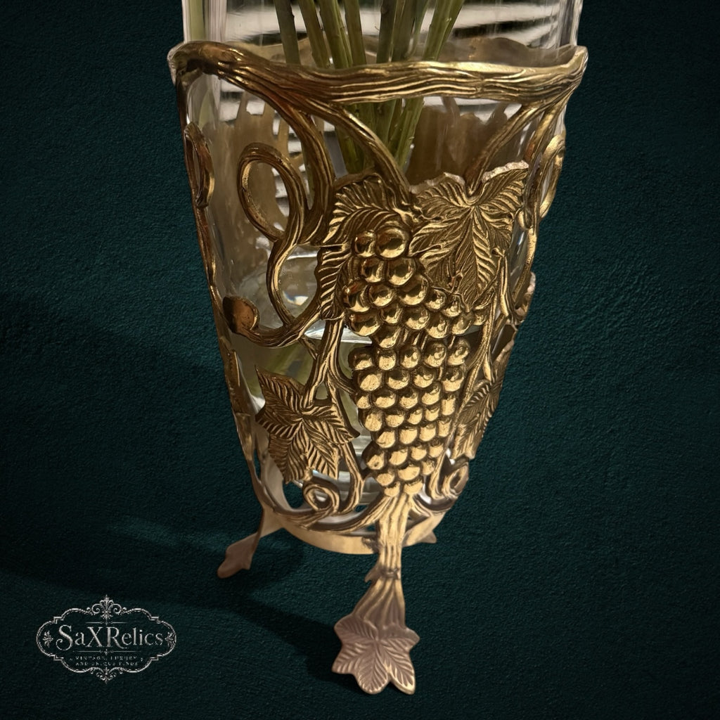 My Store SAXRelics glass flower vase featuring an ornate brass-tone metal stand with intricate grape and vine motifs.