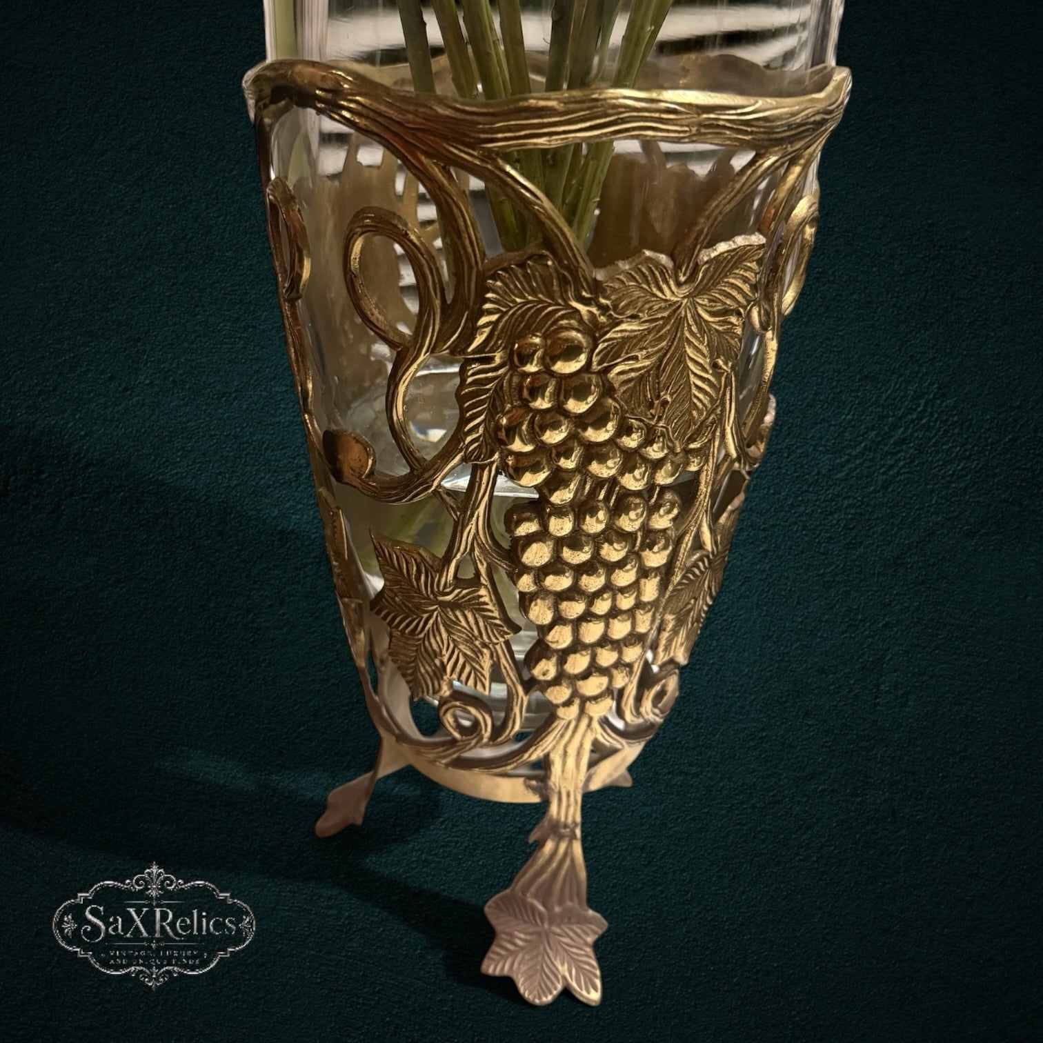 My Store SAXRelics glass flower vase featuring an ornate brass-tone metal stand with intricate grape and vine motifs.