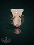My Store decorative glass vase featuring a clear hurricane shade held by an ornate bronze metal stand with winged figures