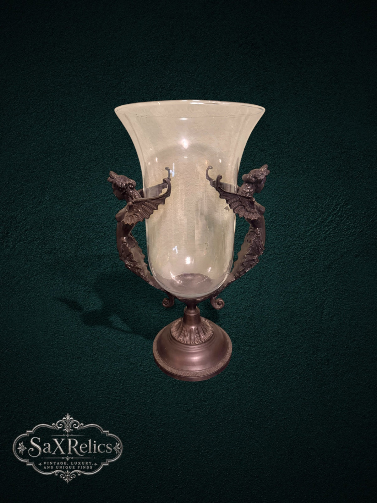 My Store decorative glass vase featuring a clear hurricane shade held by an ornate bronze metal stand with winged figures