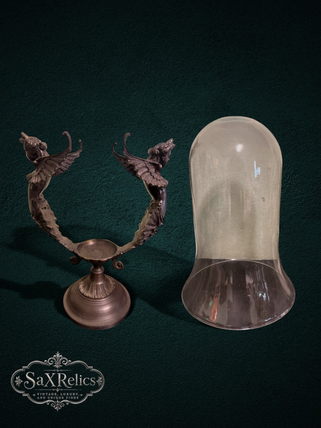 My Store decorative glass vase with an ornate bronze-toned metal stand featuring intricate winged figures.