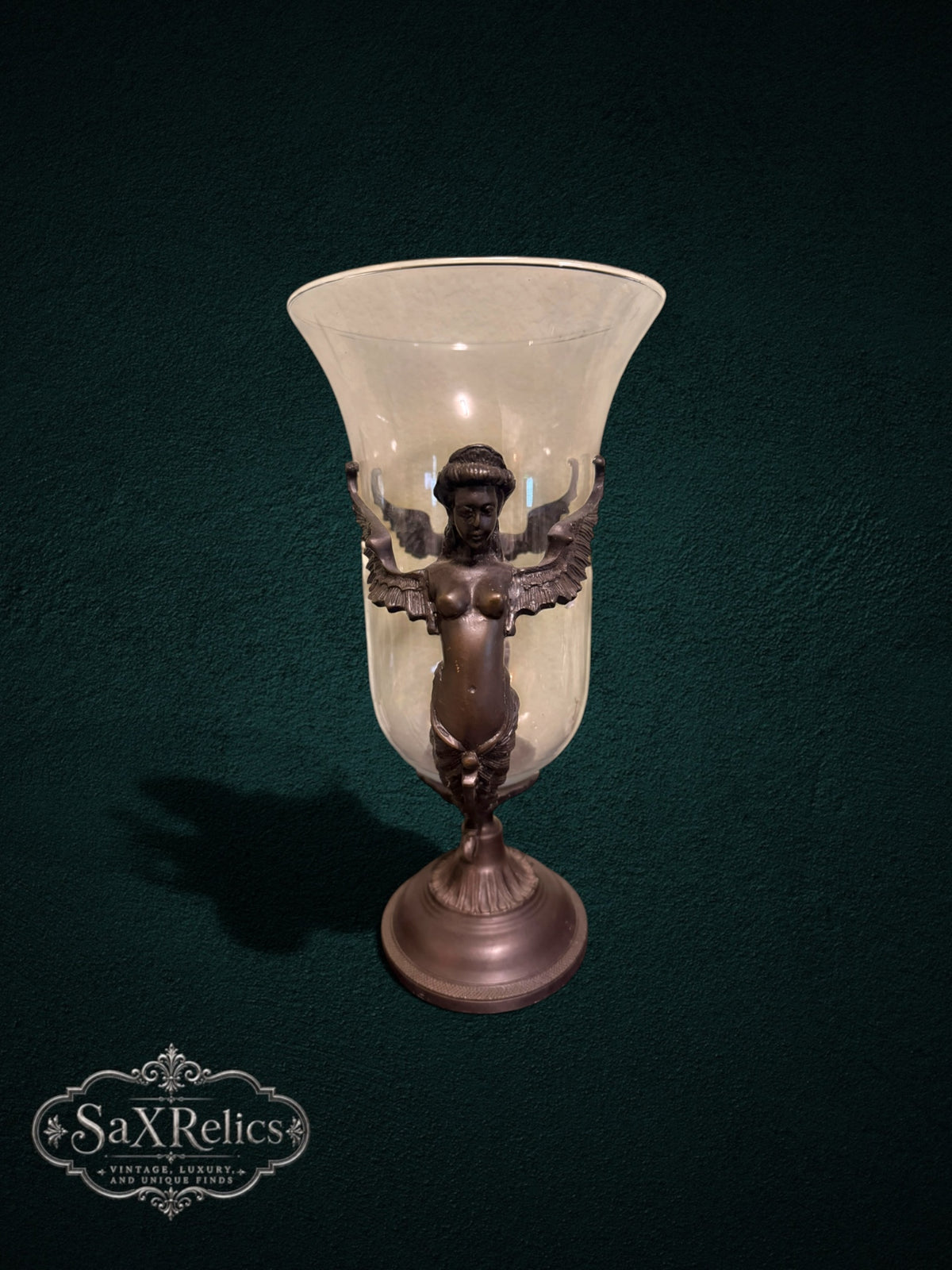 My Store decorative glass vase with an ornate bronze-toned metal stand featuring intricate winged figure accents.