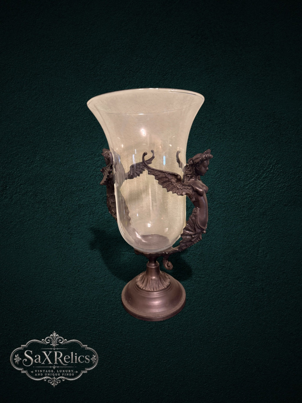 My Store decorative glass vase featuring a clear hurricane shade supported by an ornate bronze-toned winged metal stand.