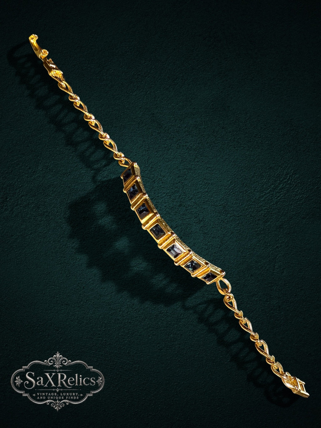 SaX Relics gold-tone link bracelet featuring square-cut midnight-blue stones on a textured chain