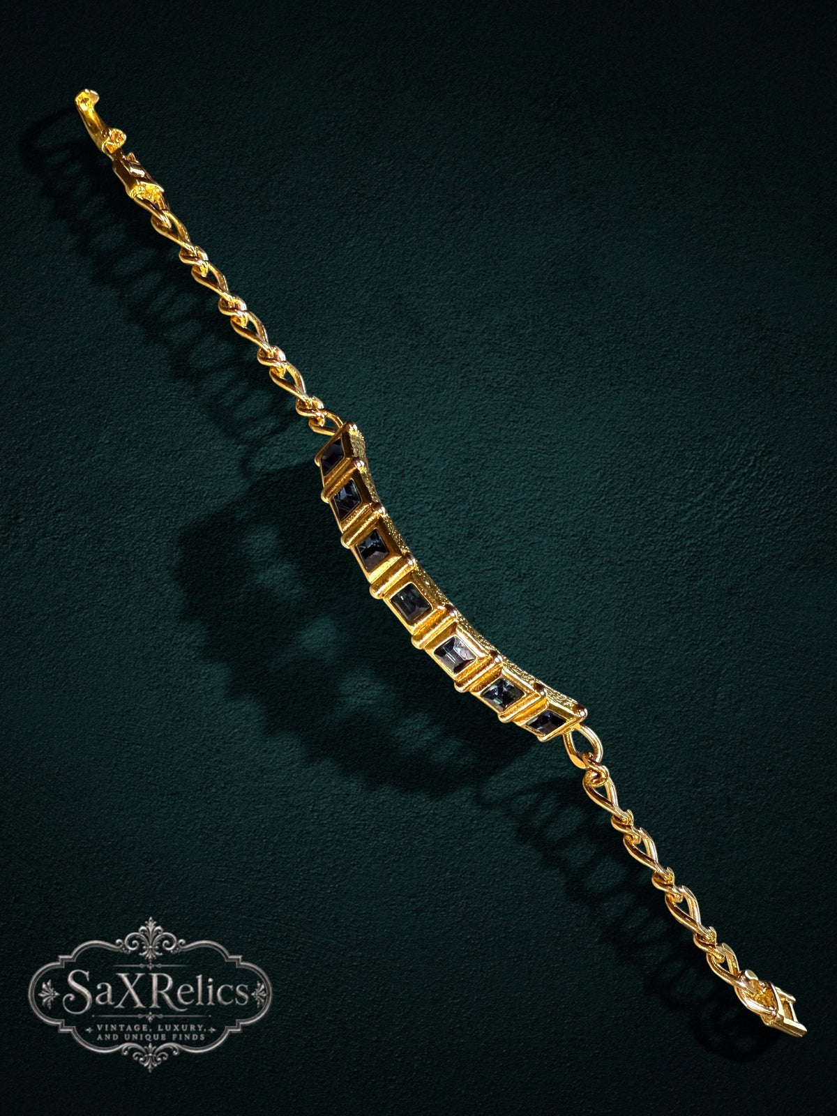 SaX Relics gold-tone link bracelet featuring square-cut midnight-blue stones on a textured chain