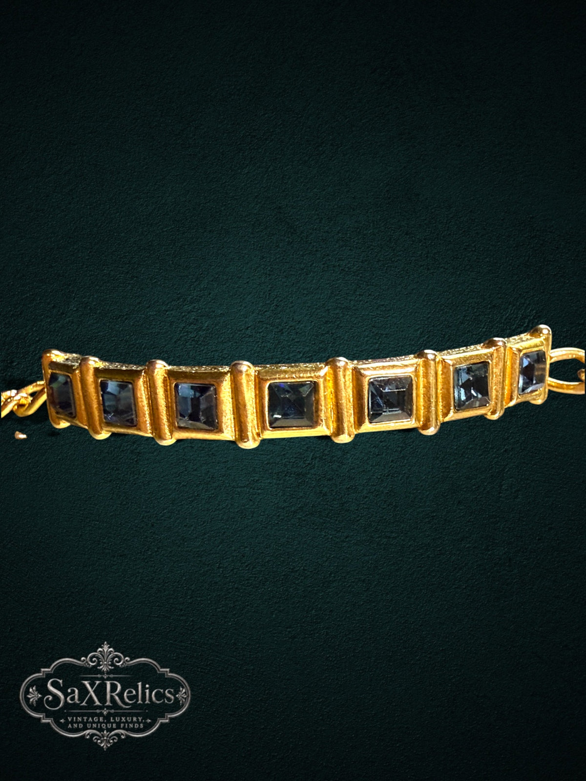 SaX Relics gold-tone link bracelet featuring square-cut midnight-blue stones in a textured vintage frame.