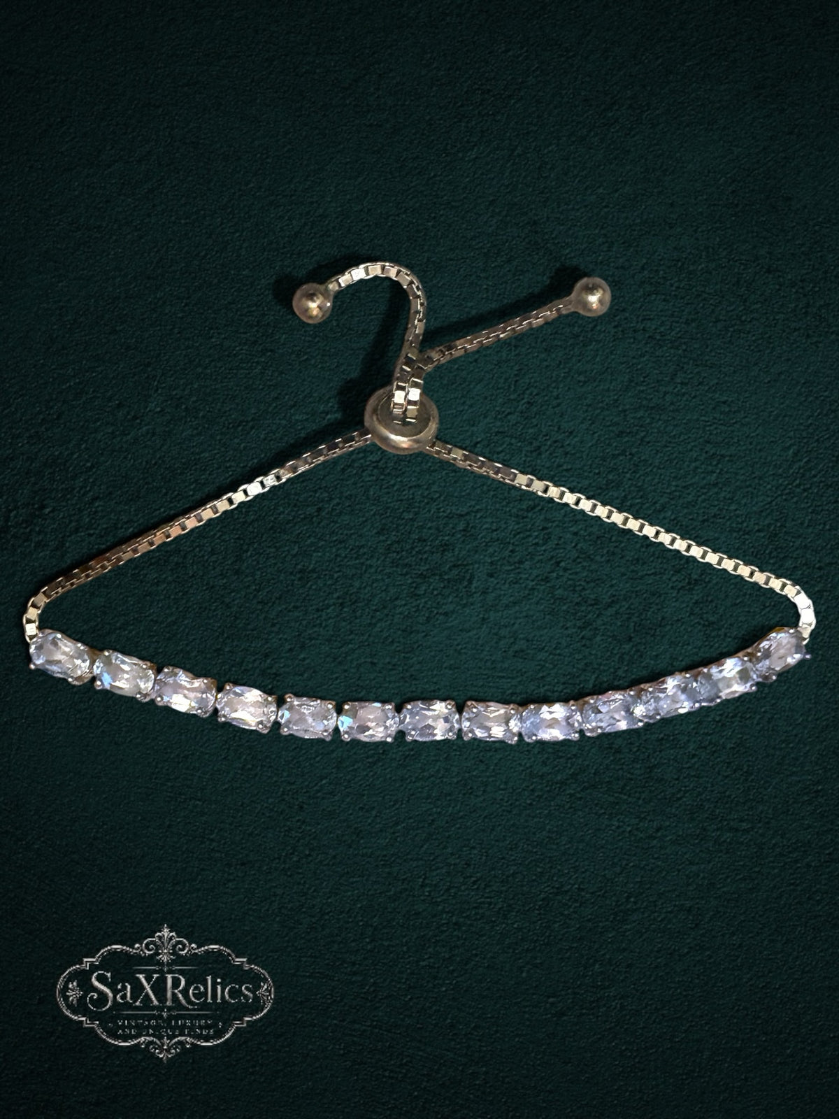 My Store gold-tone tennis bracelet with clear oval-cut crystals and an adjustable bolo-style sliding clasp.