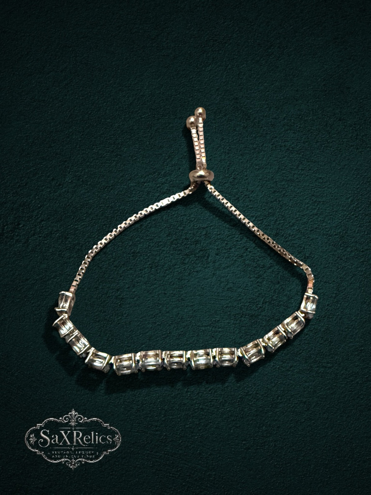 My Store adjustable tennis bracelet featuring clear oval-cut crystals in a gold-tone setting with a bolo sliding clasp