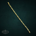 SaX Relics sterling silver Figaro chain bracelet with alternating oval and circular links on a dark textured background