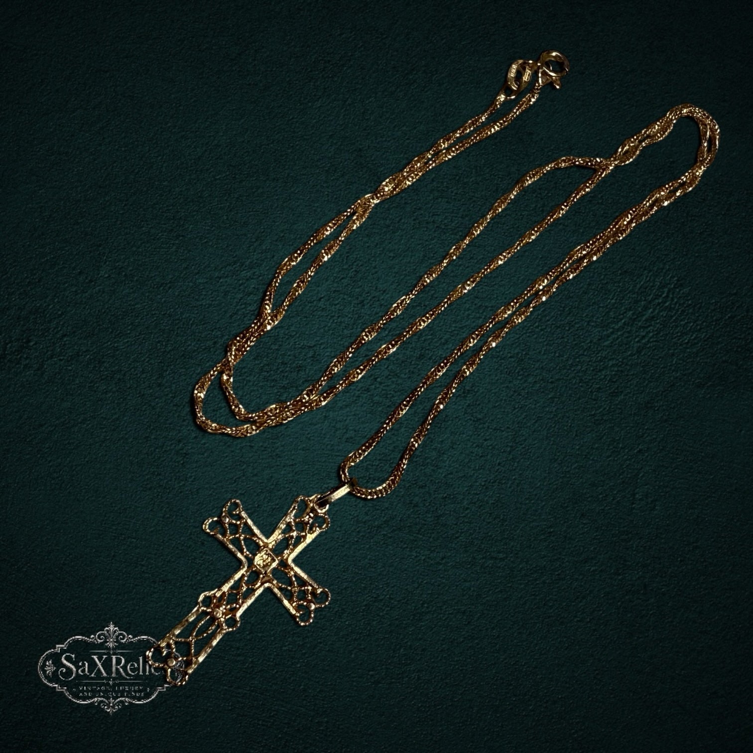 My Store 14k gold filigree cross pendant necklace with intricate openwork design on a textured dark background