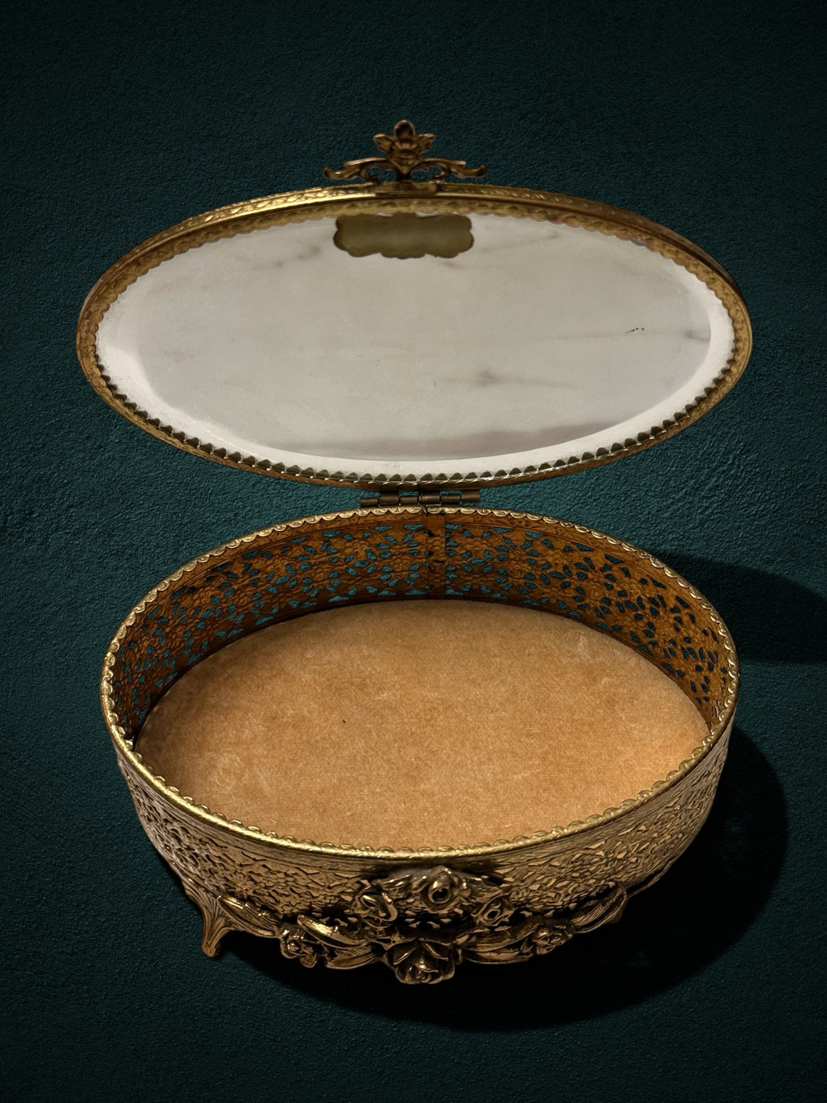 My Store ornate gold-plated oval jewelry box with intricate filigree metalwork, floral motifs, and plush velvet lining.