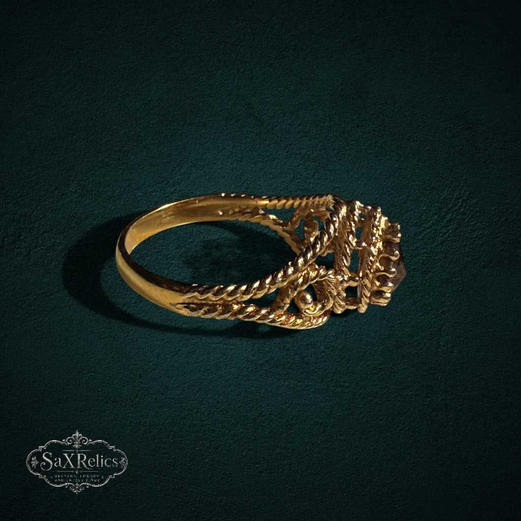 My Store SAXRelics gold ring with a pear-cut gemstone, featuring an ornate twisted rope band and filigree details.